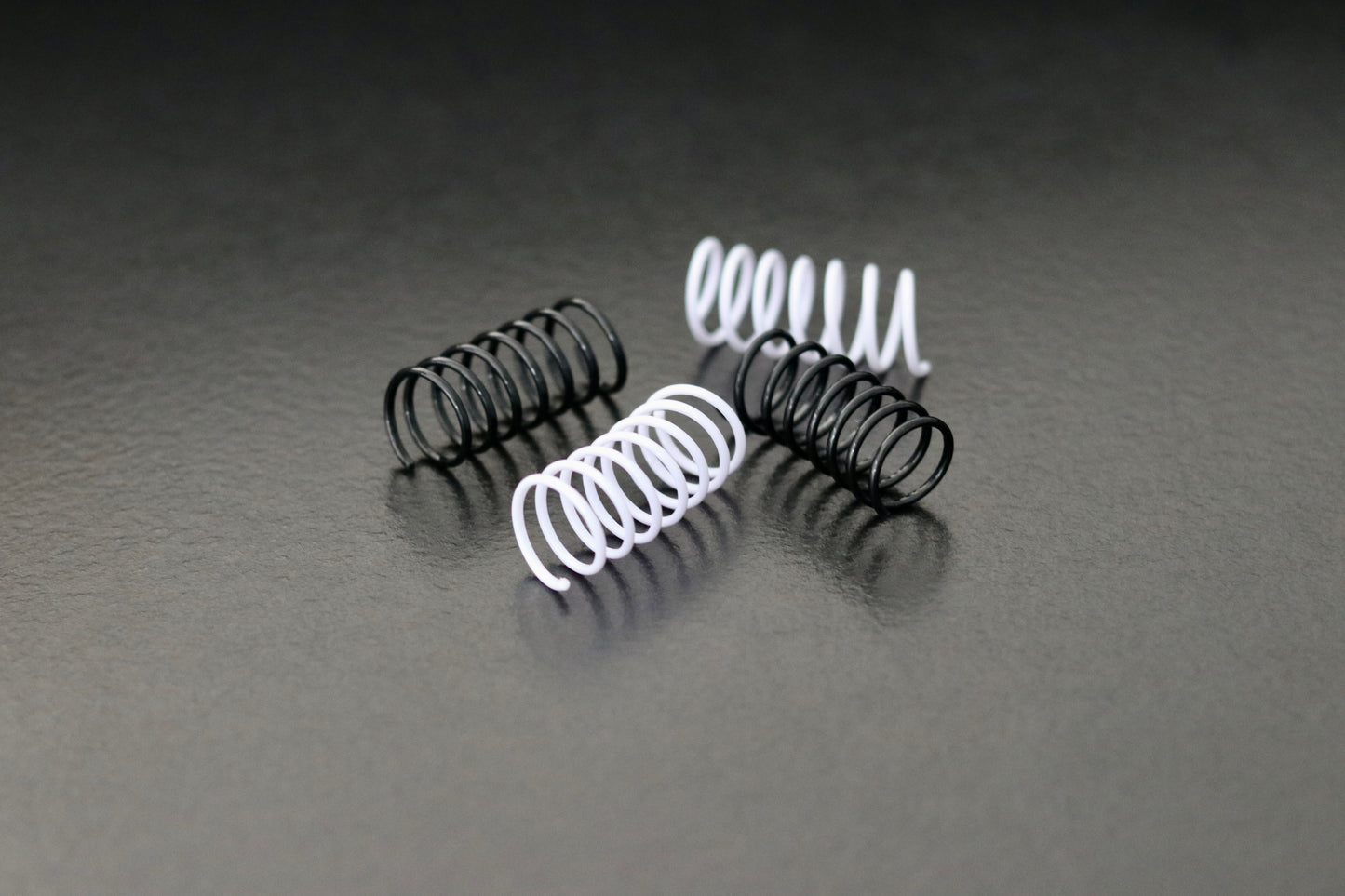 Schwarz-weiße Spielzeug-Spiralen für Katzen auf hellem Boden